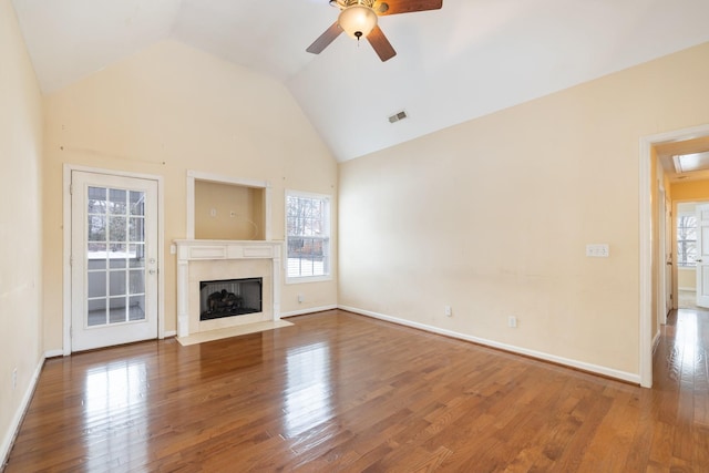 unfurnished living room with ceiling fan, wood-type flooring, a fireplace, and high vaulted ceiling