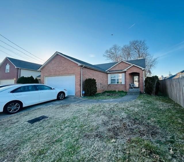 view of front of home featuring a garage and a front yard