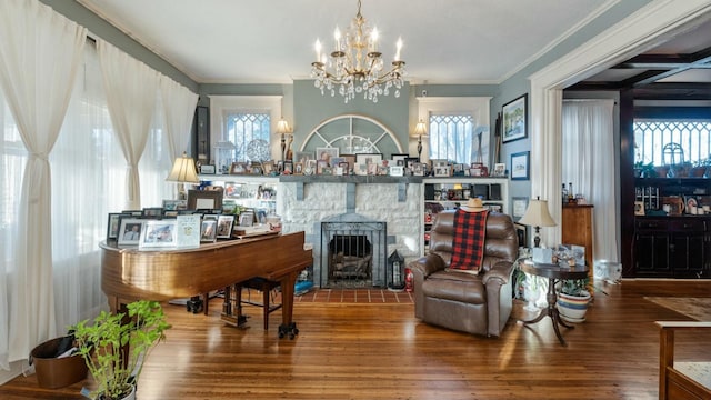 living room with crown molding, wood-type flooring, a chandelier, and a wood stove