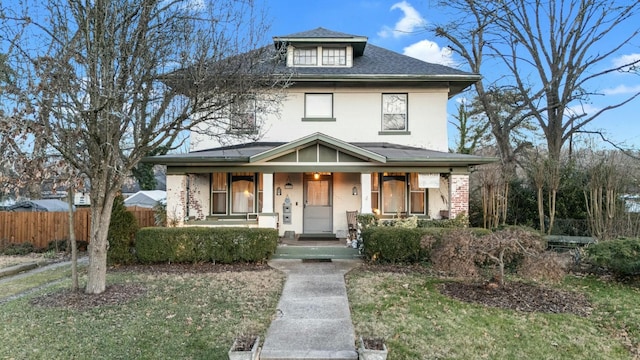 view of front of home with a porch and a front yard