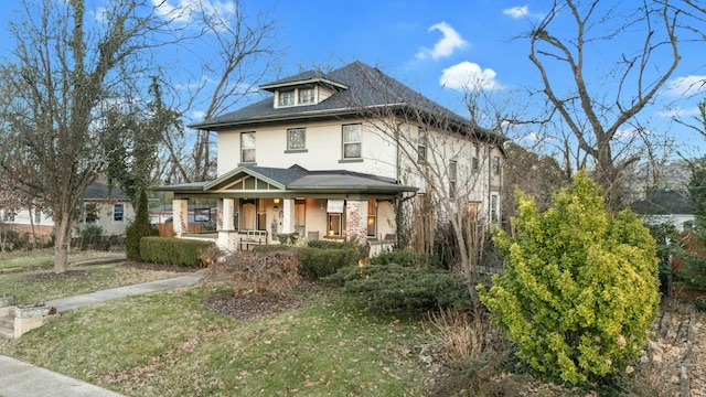 view of front of house with a front yard and a porch