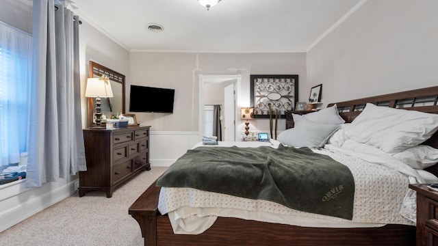 bedroom with light carpet and crown molding