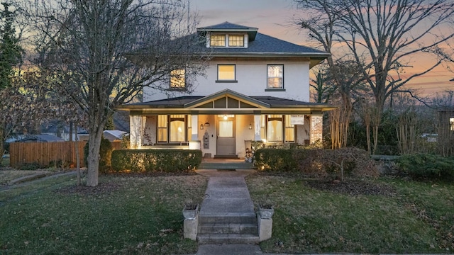 view of front facade with a lawn and a porch