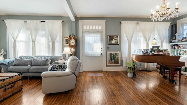 living room featuring an inviting chandelier, dark hardwood / wood-style floors, and beam ceiling