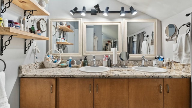 bathroom with lofted ceiling and vanity