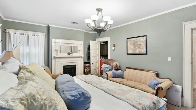 carpeted bedroom featuring a walk in closet, ornamental molding, and a notable chandelier