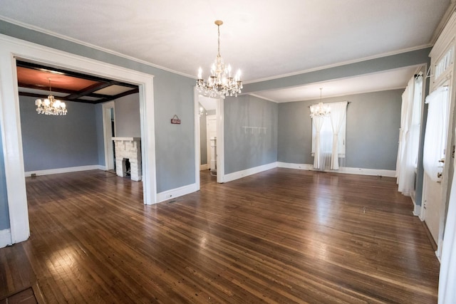 interior space featuring a notable chandelier, dark wood-style floors, ornamental molding, and a fireplace