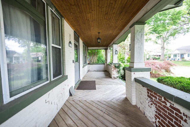 wooden terrace with a porch and a residential view