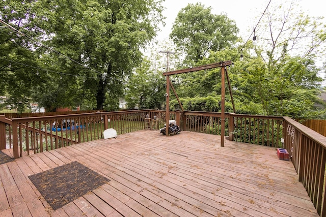 wooden deck with a fenced backyard