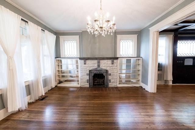 unfurnished living room with visible vents, crown molding, wood finished floors, baseboards, and a notable chandelier