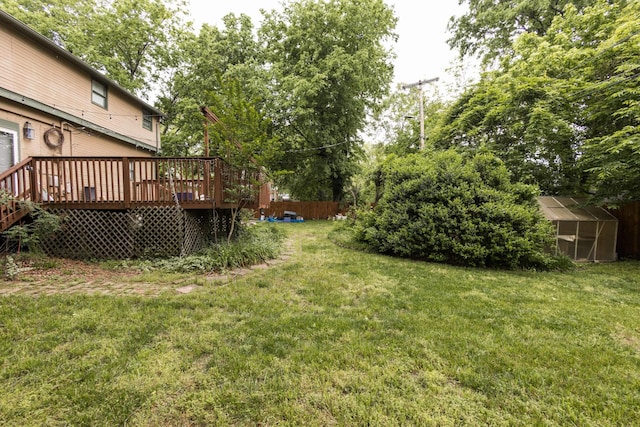 view of yard with an outdoor structure, an exterior structure, and a deck