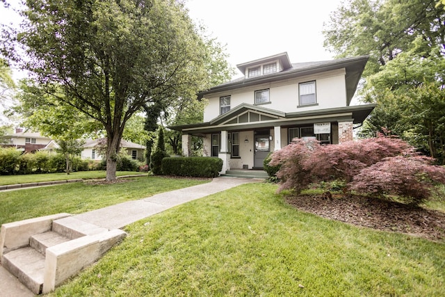 traditional style home featuring covered porch, stucco siding, and a front yard