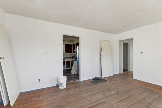 unfurnished room with wood-type flooring