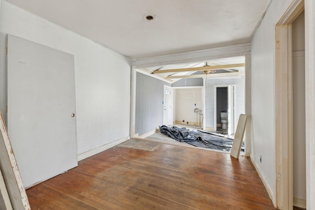 interior space featuring beamed ceiling and wood-type flooring