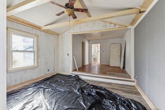 empty room featuring lofted ceiling, hardwood / wood-style floors, and ceiling fan