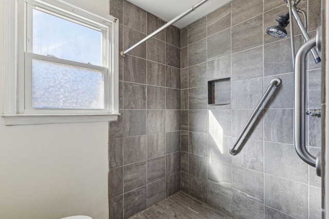 bathroom with a tile shower