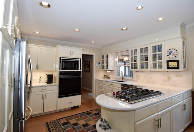 kitchen featuring sink, white cabinetry, backsplash, ornamental molding, and black appliances