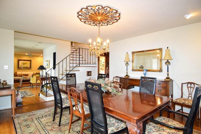 dining area with dark hardwood / wood-style flooring and a notable chandelier