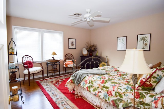 bedroom with dark wood-type flooring and ceiling fan