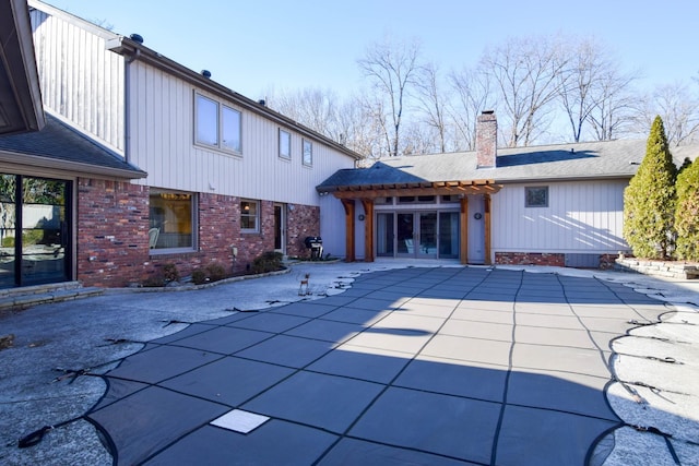 rear view of property with french doors and a patio area