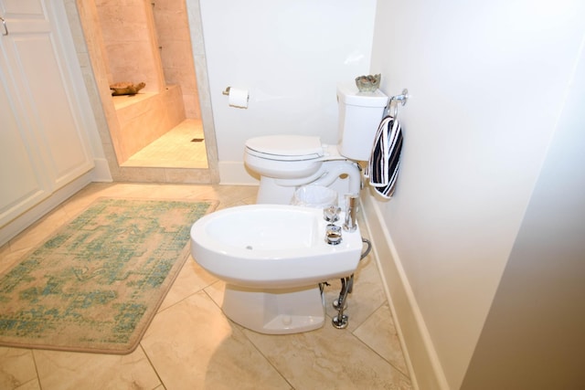 bathroom with tile patterned flooring, a bidet, tiled shower, and toilet