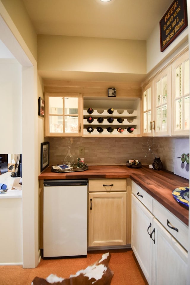 kitchen with dishwasher, wood counters, and decorative backsplash