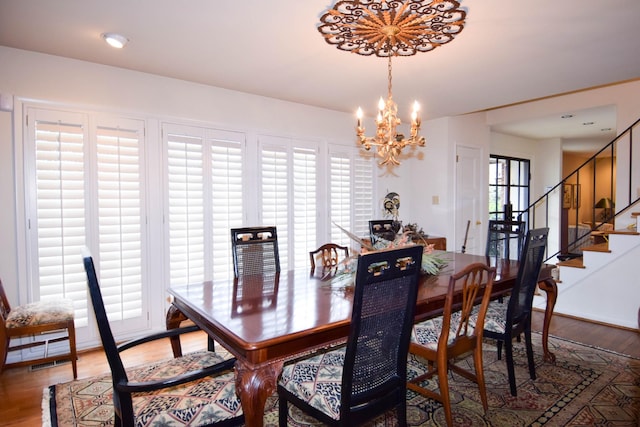 dining area featuring an inviting chandelier, hardwood / wood-style floors, and a wealth of natural light