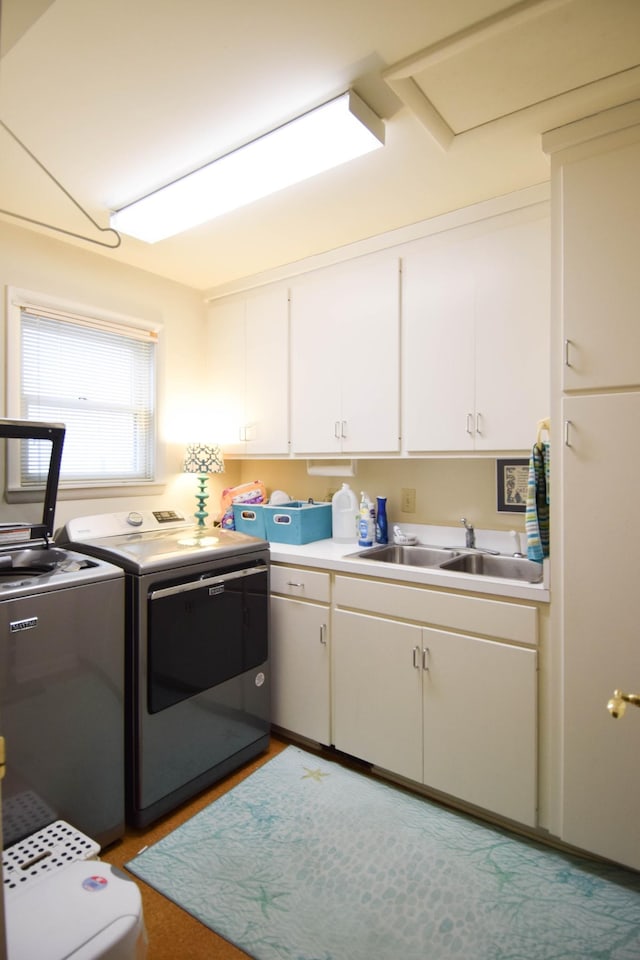 laundry area featuring cabinets, sink, and independent washer and dryer