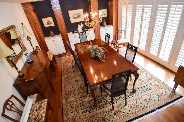 dining area with a notable chandelier and wood-type flooring