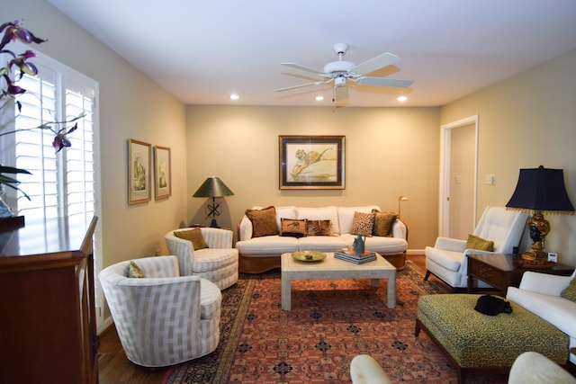 living room featuring dark hardwood / wood-style floors and ceiling fan