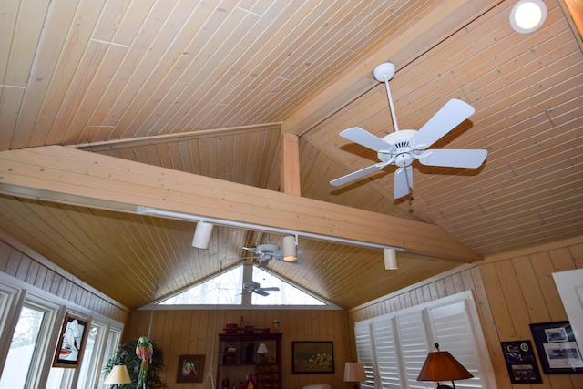 room details featuring ceiling fan and wood walls