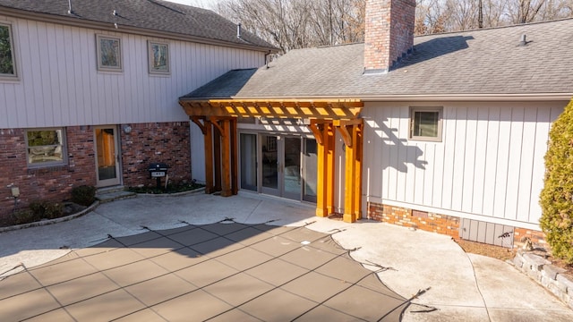 rear view of house with a pergola and a patio