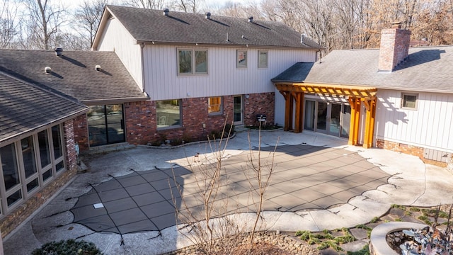 back of house with a pergola and a patio area