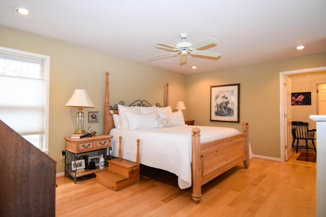 bedroom with multiple windows, ceiling fan, and light wood-type flooring