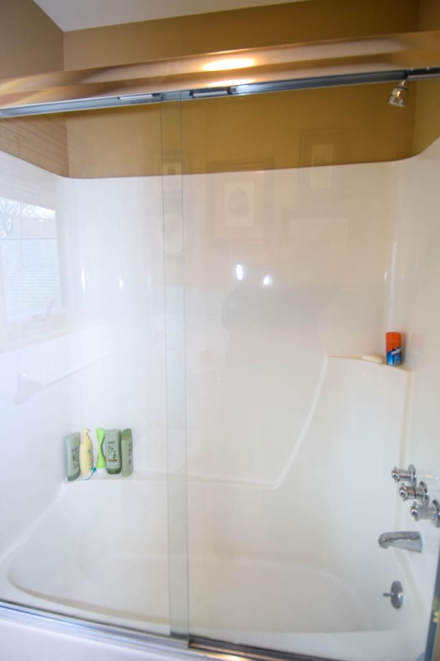 bathroom with shower / bath combination with glass door