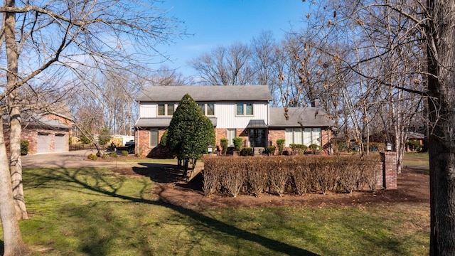 view of front of property with a garage and a front lawn