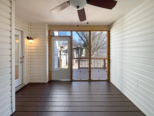 unfurnished sunroom with ceiling fan