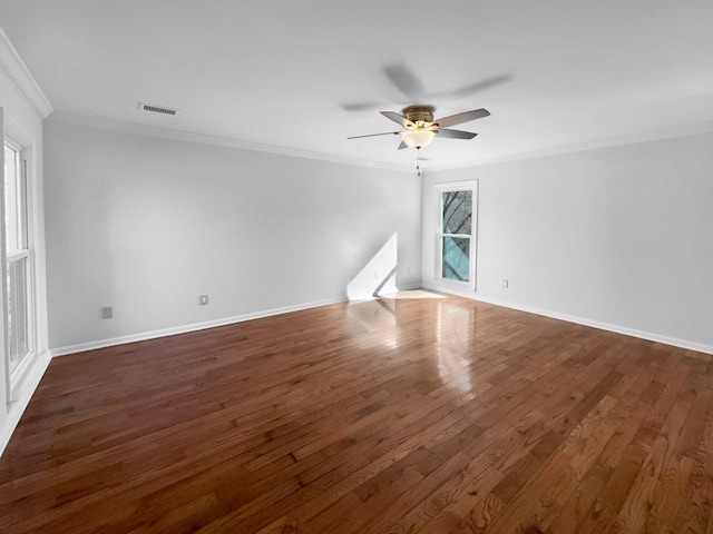 empty room featuring dark hardwood / wood-style flooring, crown molding, and ceiling fan