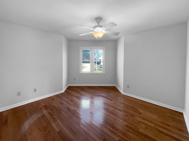 spare room with ceiling fan and dark hardwood / wood-style flooring