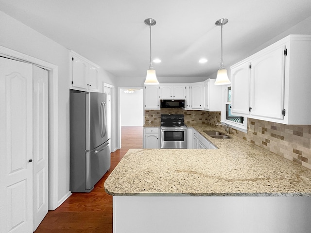 kitchen with pendant lighting, sink, white cabinetry, stainless steel appliances, and kitchen peninsula