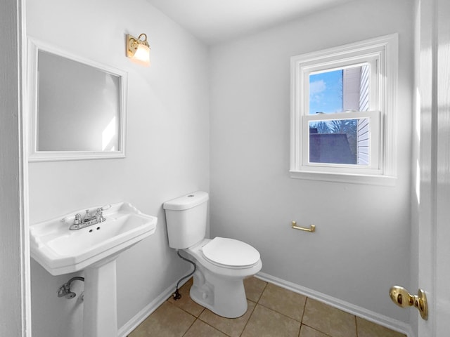 bathroom featuring toilet and tile patterned flooring