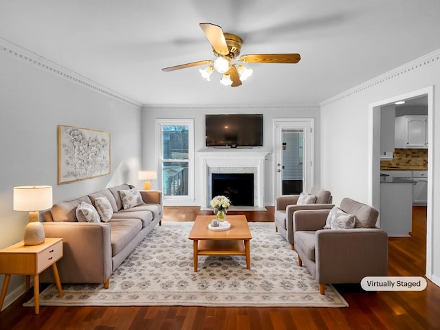 living room with crown molding, hardwood / wood-style floors, and ceiling fan