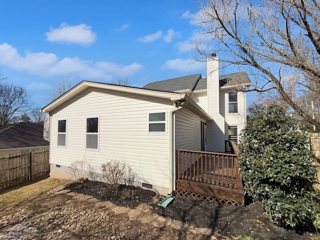 view of side of property with a wooden deck