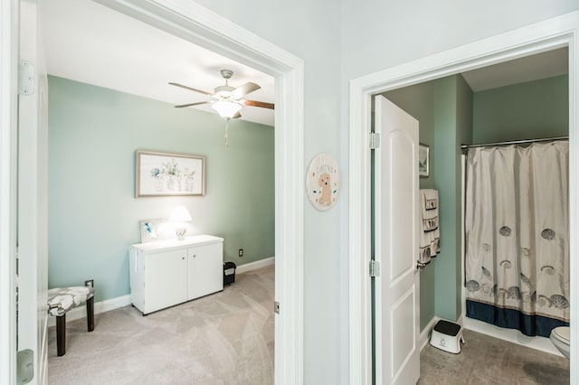 bathroom featuring ceiling fan and toilet