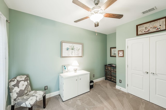 laundry room featuring ceiling fan and light colored carpet