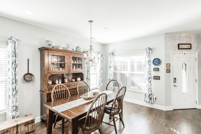 dining area featuring dark hardwood / wood-style floors and a chandelier