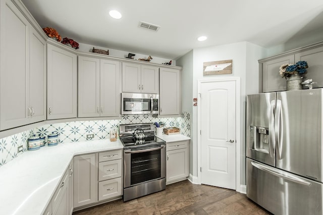 kitchen featuring stainless steel appliances, tasteful backsplash, and dark hardwood / wood-style flooring