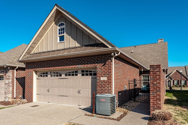 view of side of property with a garage and central air condition unit