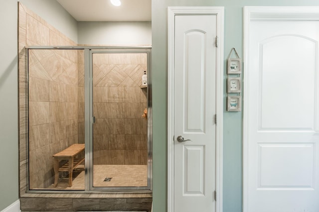 bathroom featuring a shower with door