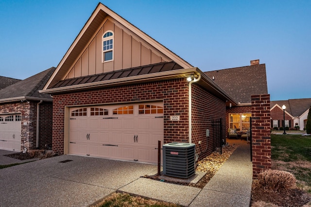 view of side of property featuring a garage and central air condition unit